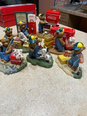 Coca-Cola Bear Figurine Collection with Red Coolers and Blue Overalls